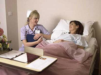 Picture showing a St Anthony's Hospital nurse talking to a female patient
