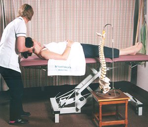 Picture showing a Physiotherapist giving neck treatment to a patient